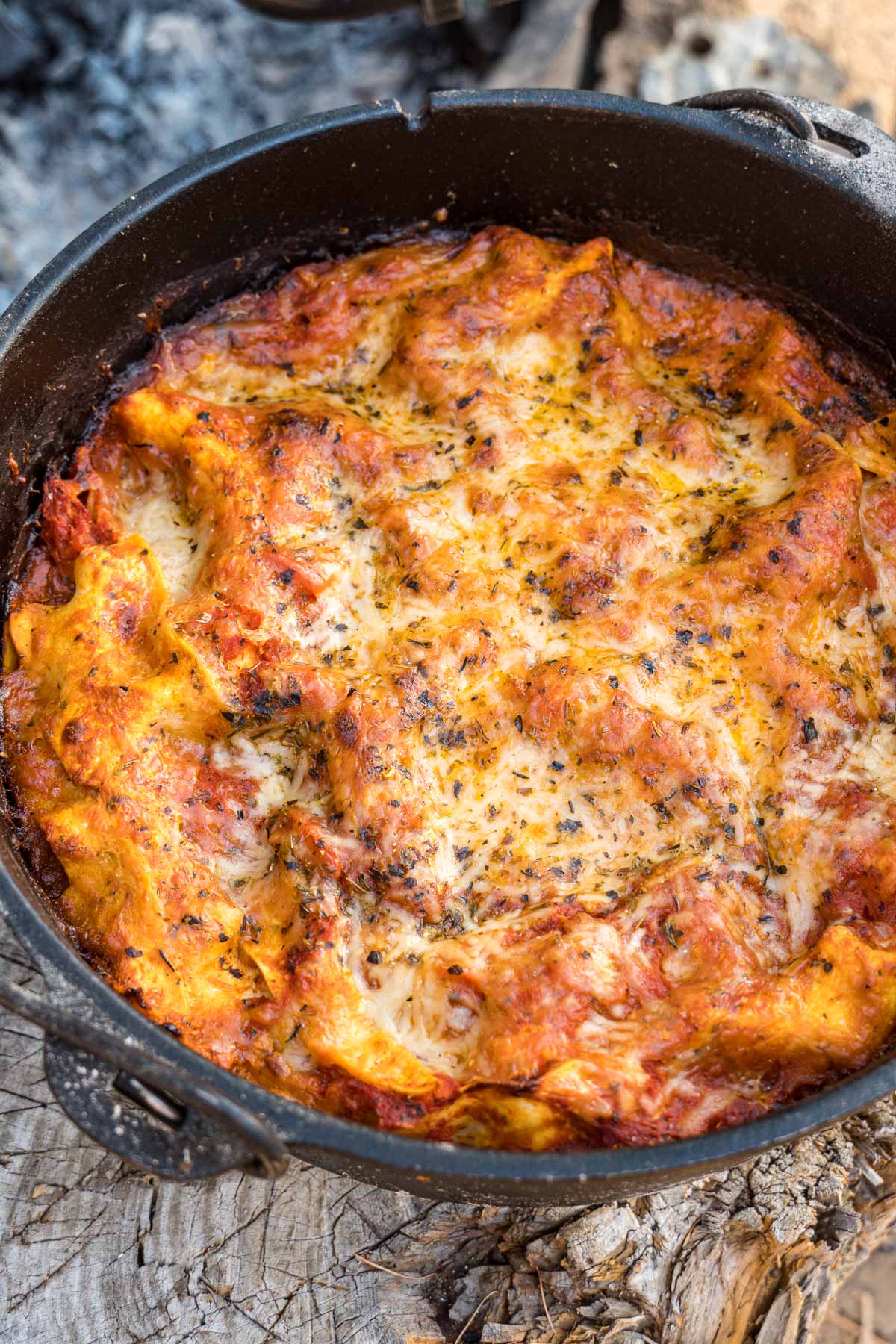 Dutch oven lasagna on a log.