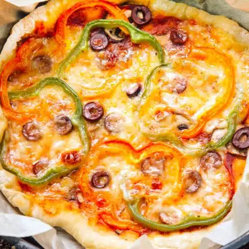 Pizza with cheese, bell peppers, and olives.