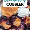 A delicious dutch oven blueberry cobbler topped with whipped cream.