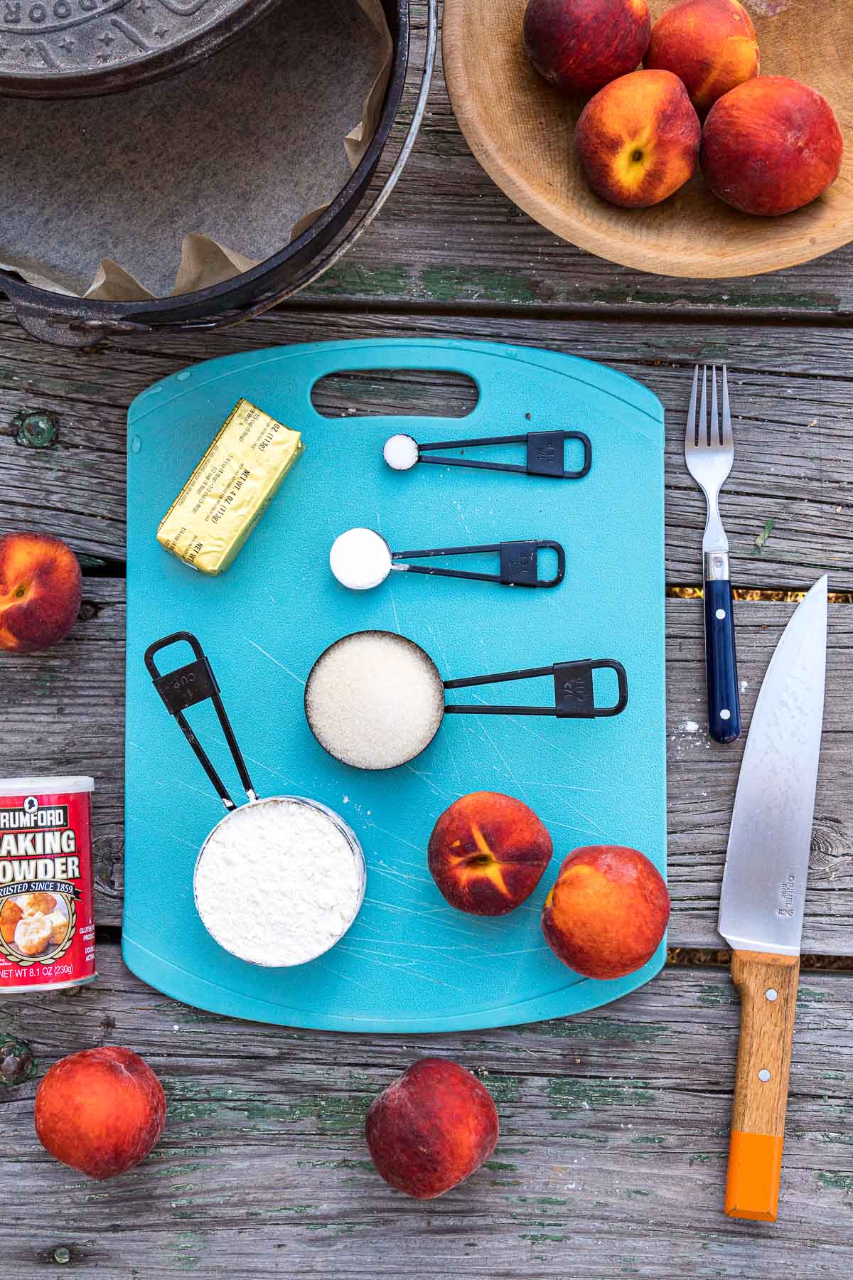 Ingredients for peach cobbler on a cutting board