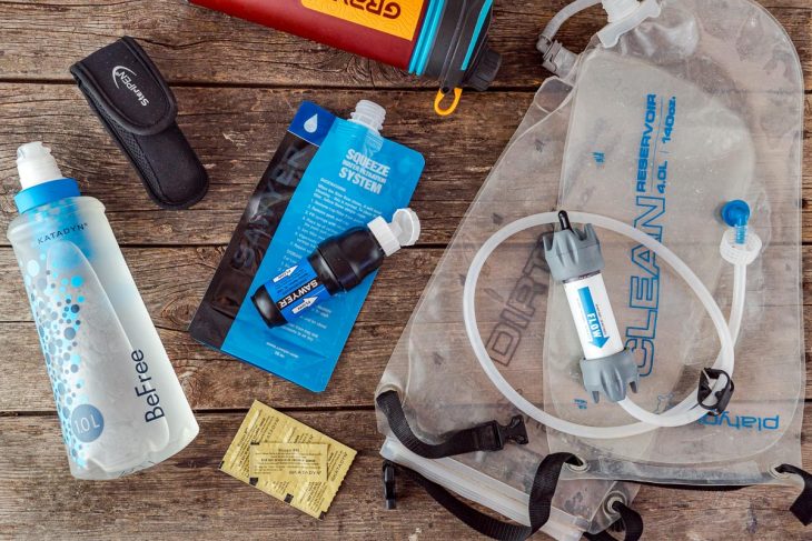 An overhead view of a variety of backpacking water filter options