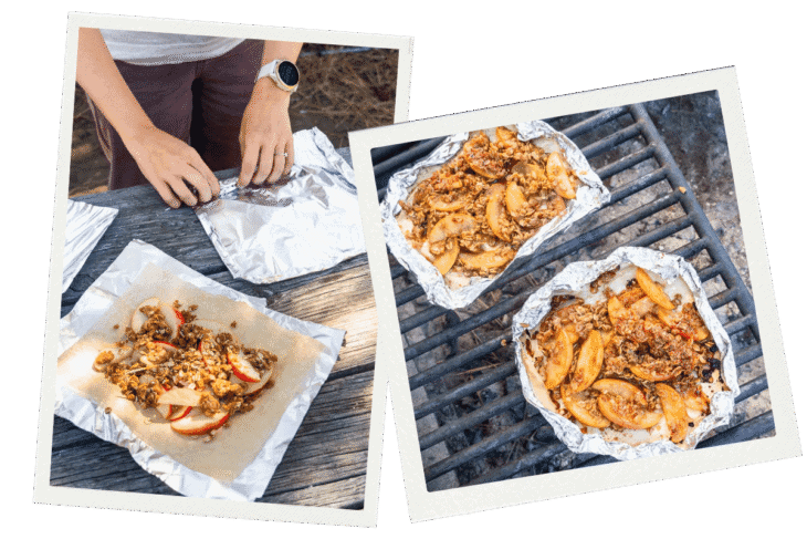A person wraps ingredients in foil on a picnic table, with two foil packets resting on a grill grate over a campfire nearby.