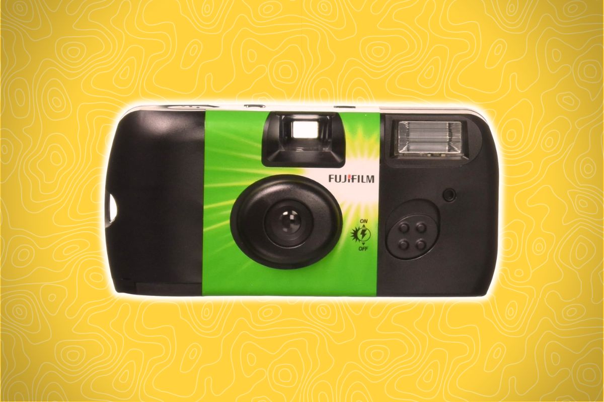 A green and black Fujifilm disposable camera sits centered on a yellow background with abstract wavy lines.