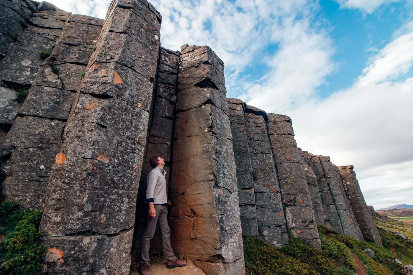 Man standing among the basalt columns of the Gerduberg Cliffs