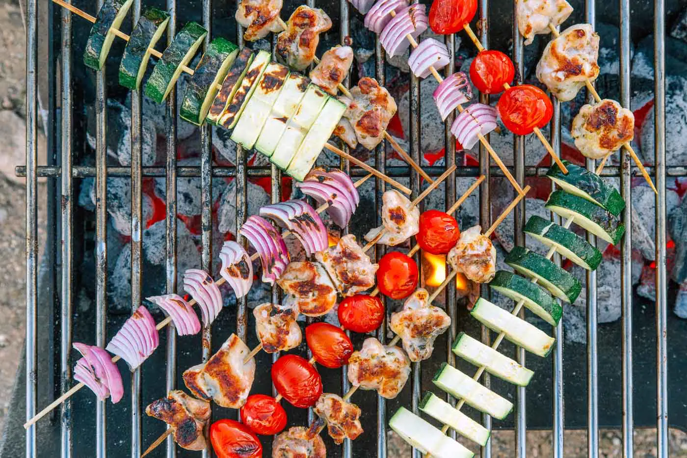 Skewered vegetables and chicken on a grill