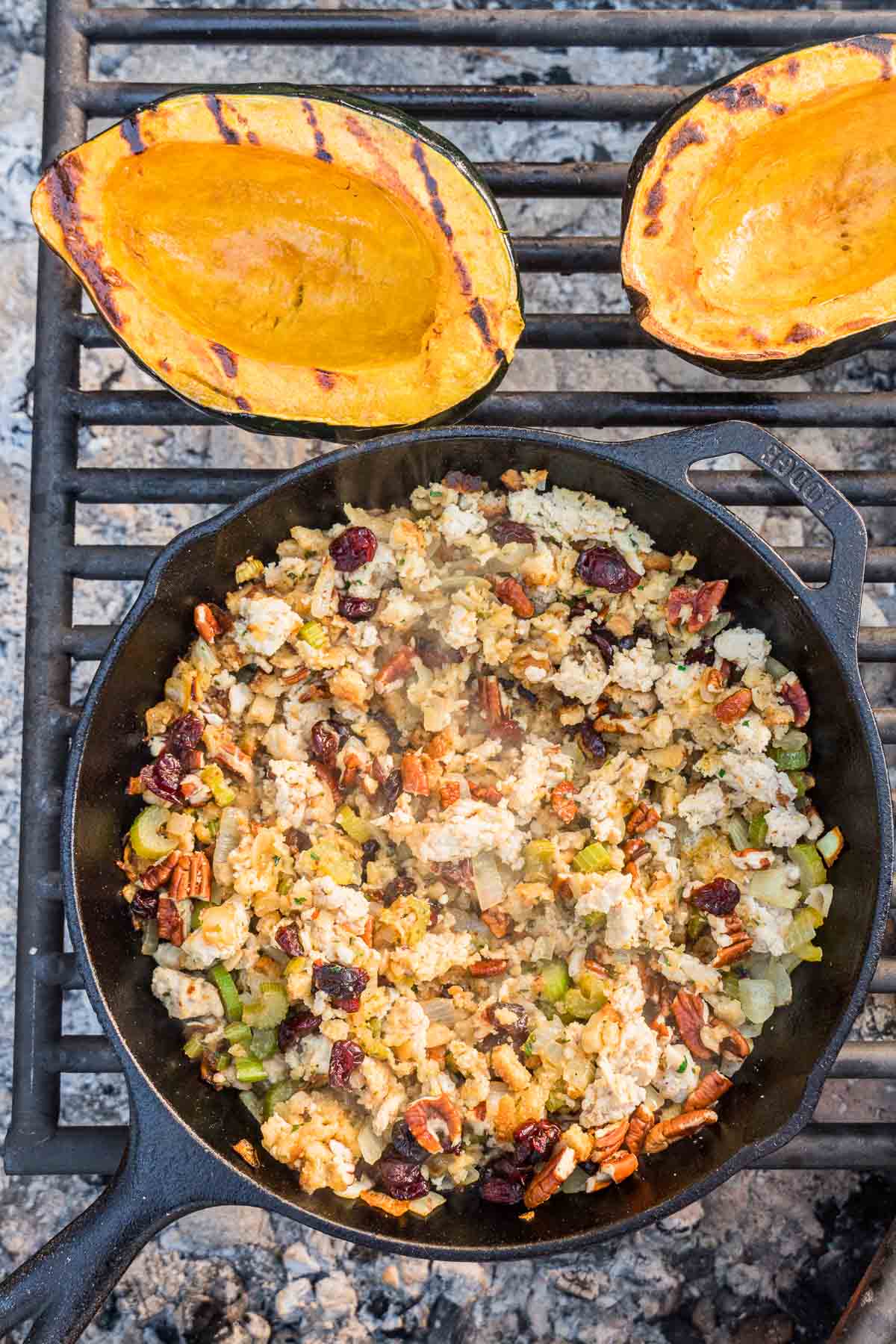 Stuffing in a cast iron skillet on a grill grate.