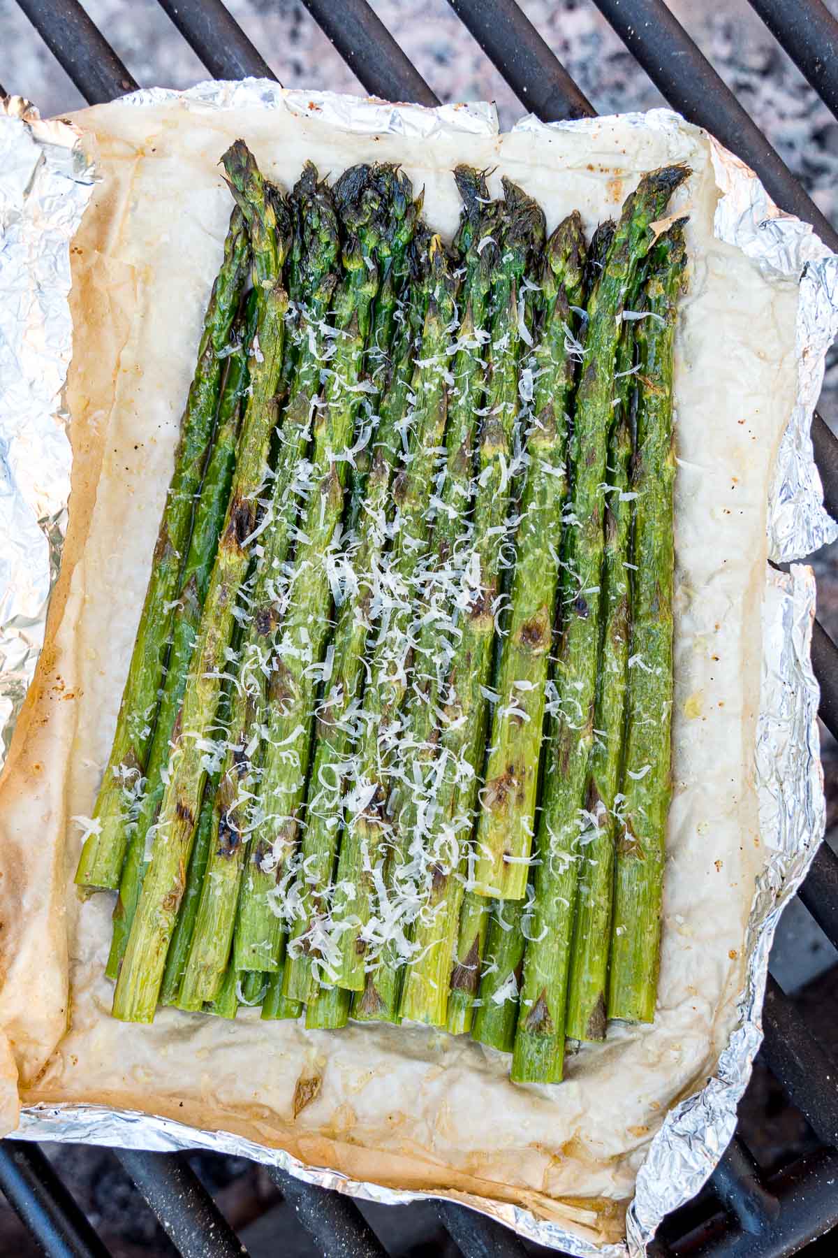 Grilled asparagus in foil over a grill grate