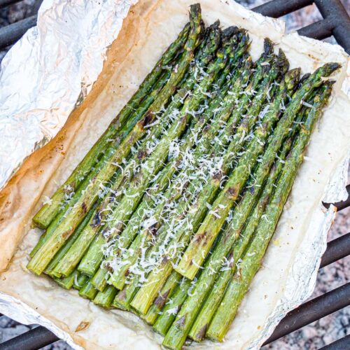 Grilled asparagus in foil on a grill grate