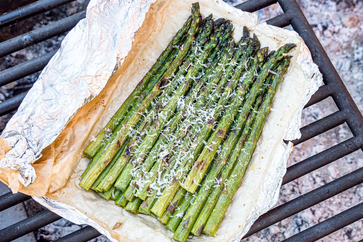 Grilled asparagus in foil on a grill grate
