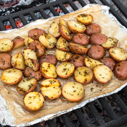 Grilled potatoes in foil over a fire pit