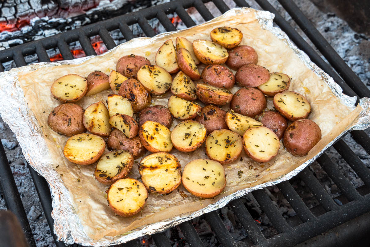 Grilled potatoes in foil over a fire pit