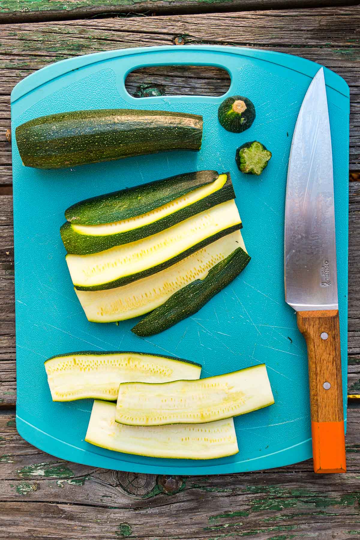 Sliced zucchini on a blue cutting board