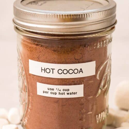 A mason jar with hot cocoa mix inside. The label reads “hot cocoa, use ¼ cup hot cocoa per cup hot water.”