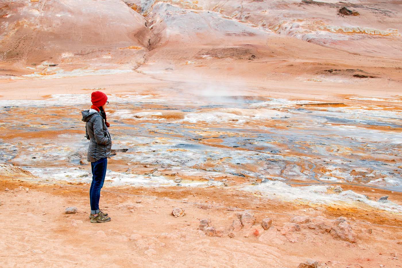 Woman standing in front of the Hverir geothermal field