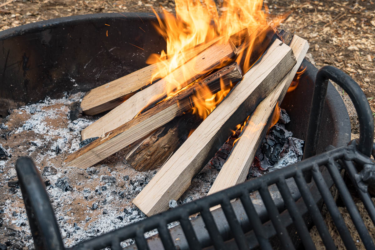 Wood logs arranged in a lean-to campfire formation