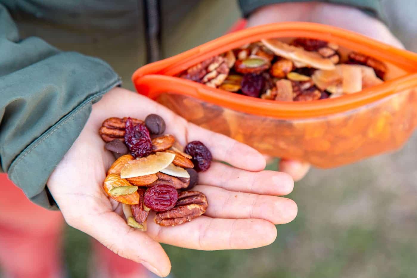 Megan holding a handful of homemade granola