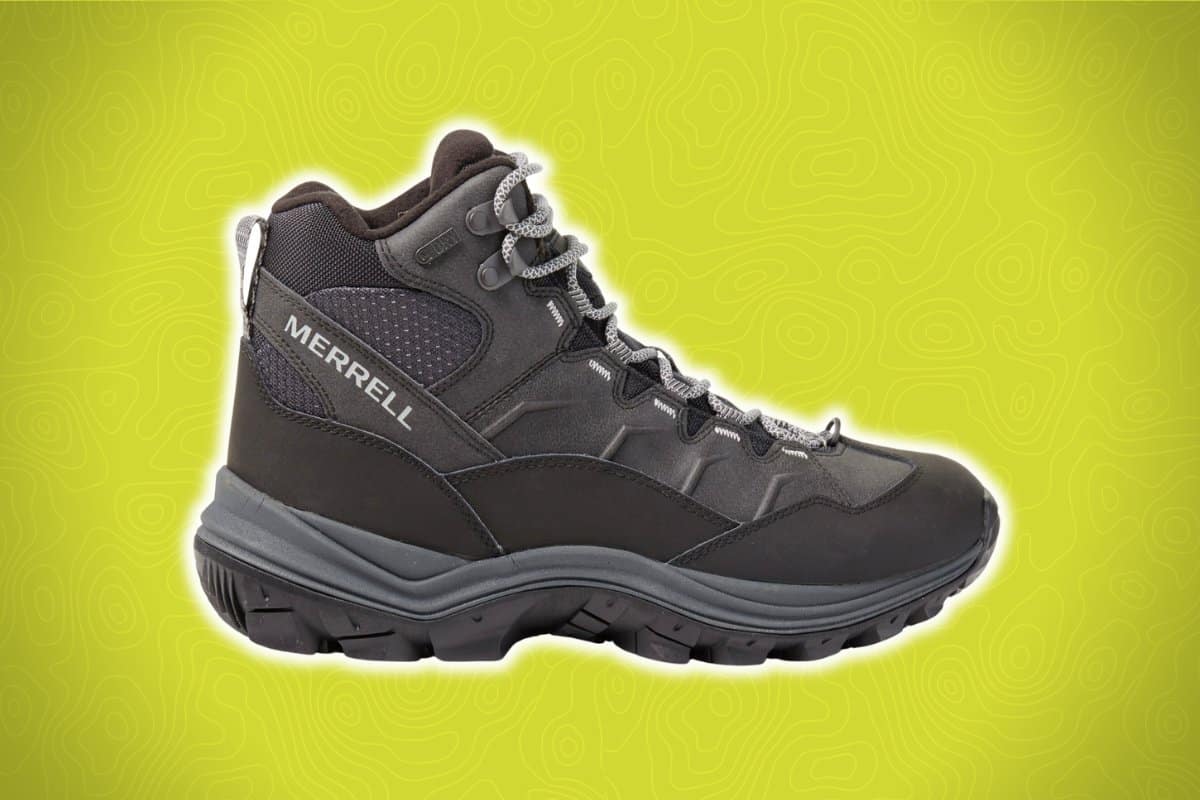 A black hiking boot with visible laces, a rugged sole, and the brand name "Merrell" on the side is set against a bright green background with contour patterns.
