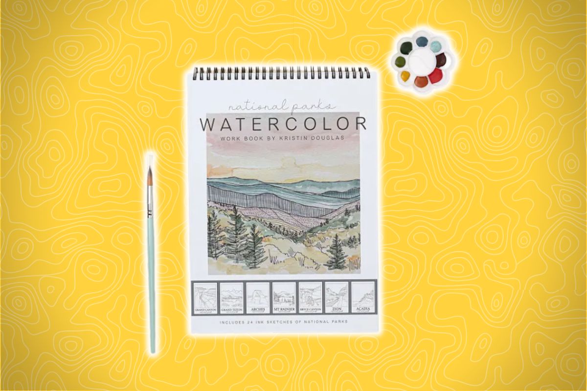 A spiral-bound workbook with a hand-drawn landscape cover, paintbrush, and six-color palette on a yellow background with topographic lines.
