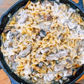 Beef stroganoff with noodles in a cast iron skillet
