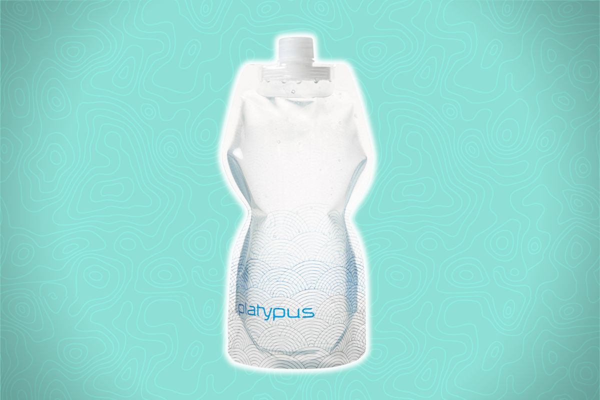 A clear, collapsible water bottle with a white cap and blue "platypus" label sits against a light teal background with swirls.