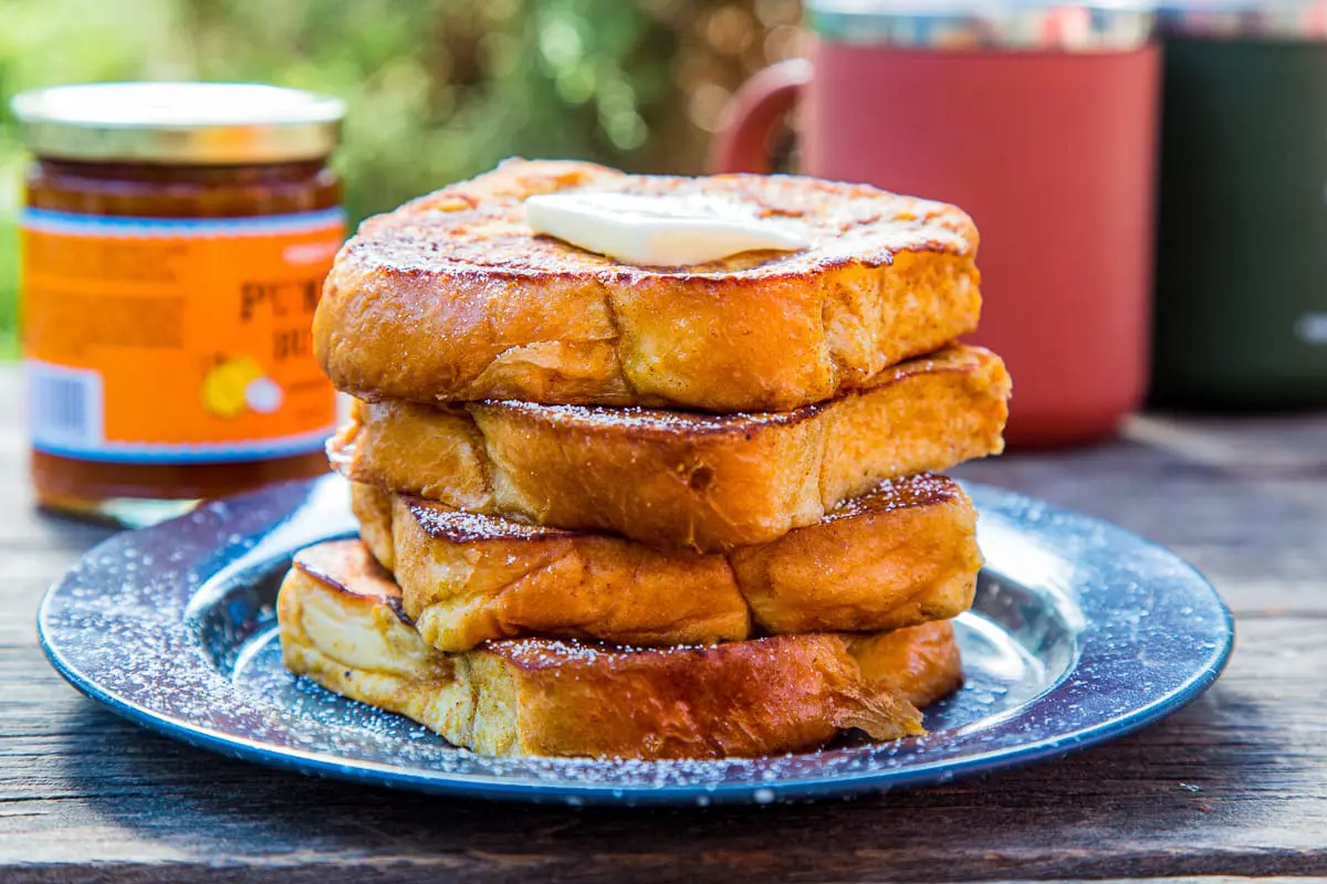 Four slices of pumpkin French toast stacked on a plate