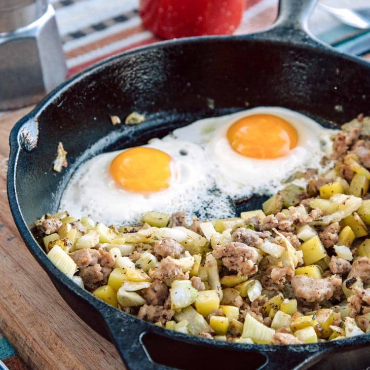Sausage and fennel hash with two eggs in a skillet