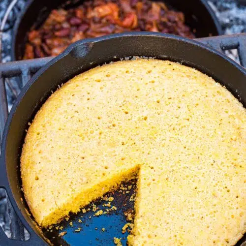 Cornbread in a skillet over a campfire