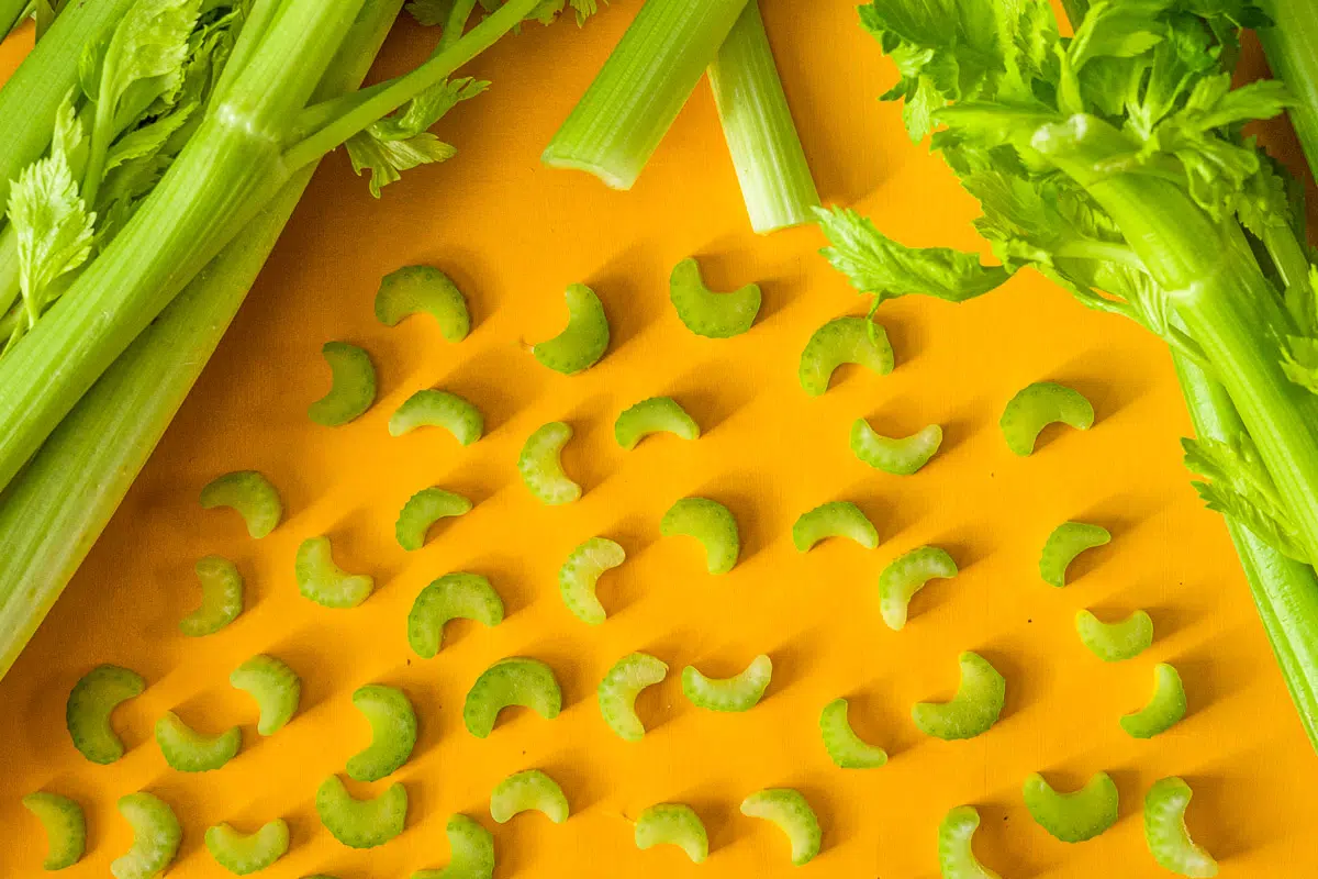 Sliced celery on a yellow background