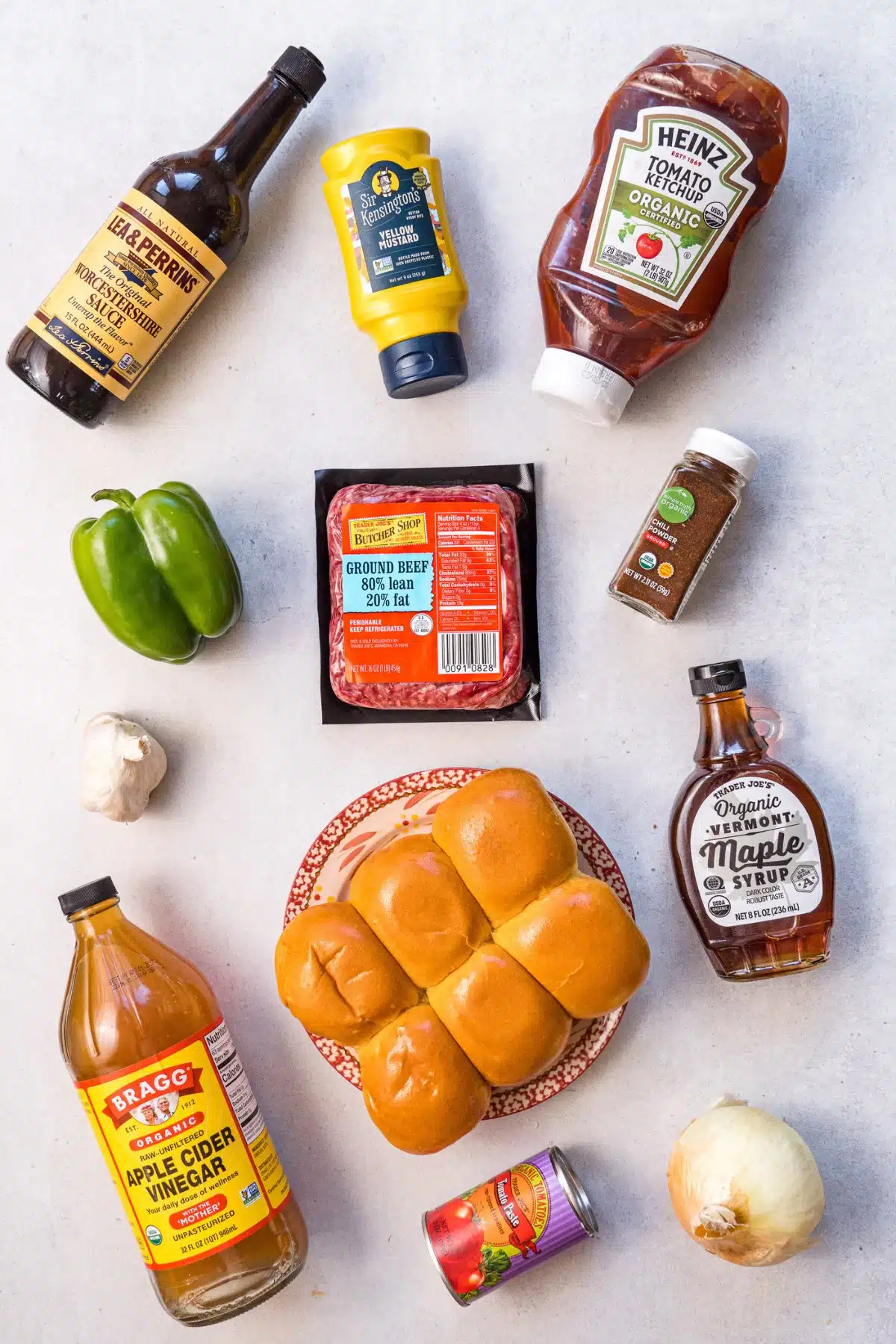 Ingredients for sloppy joes: Ground beef, Worcestershire sauce, mustard, ketchup, green bell pepper, chili powder, pure maple syrup, garlic, apple cider vinegar, tomato paste, onion, and buns. 