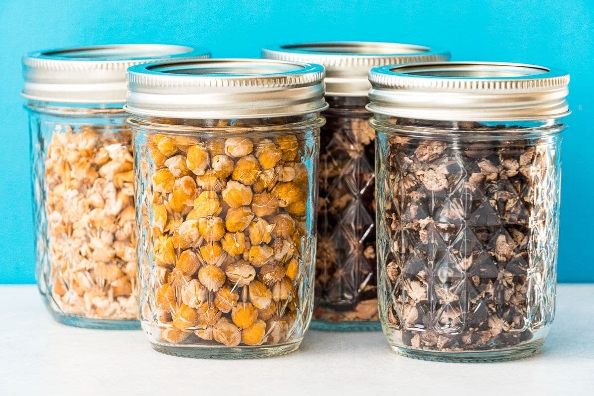 Four types of dehydrated beans in glass jars