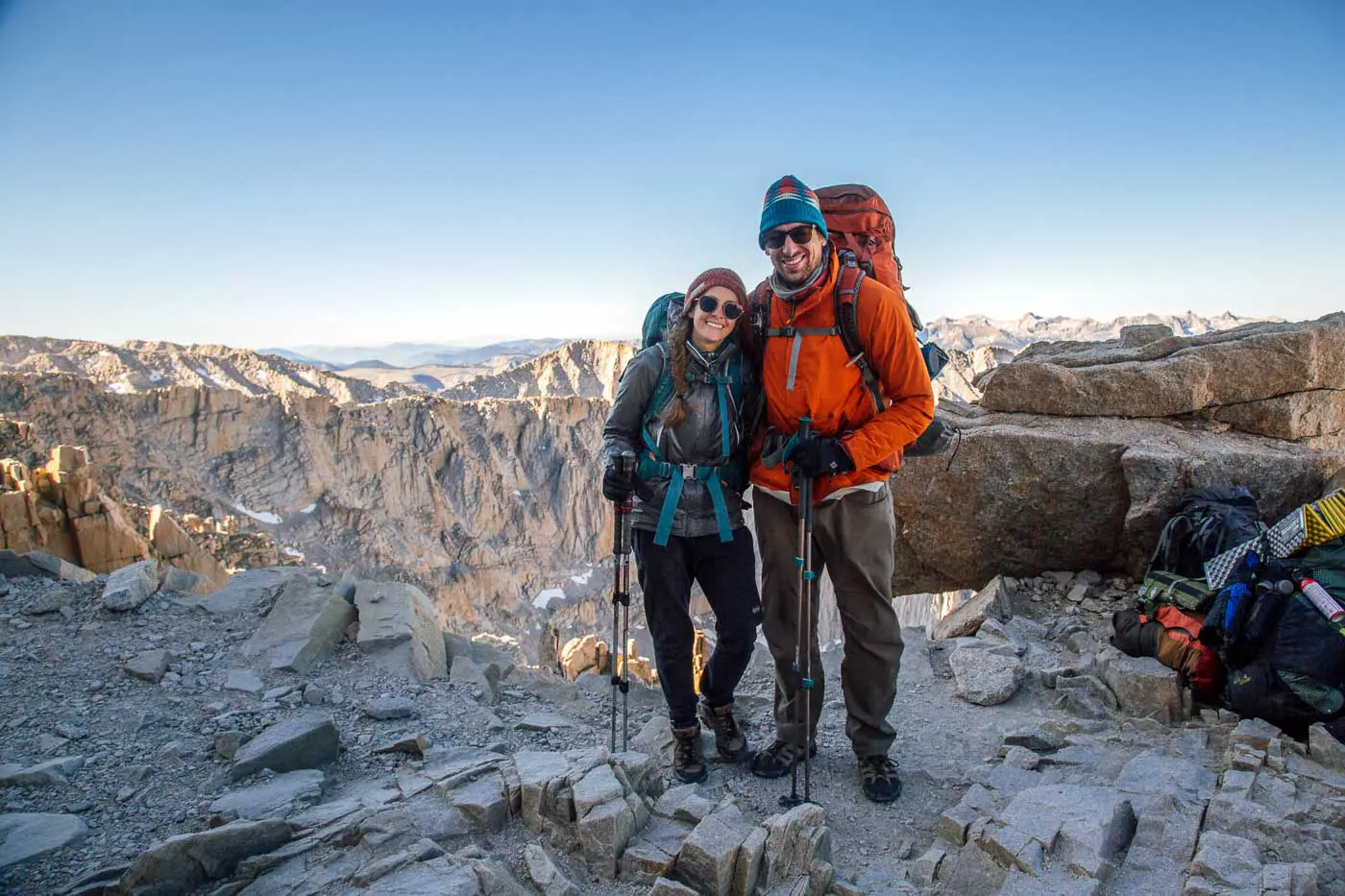 Megan and Michael wearing backpacking packs in the mountains