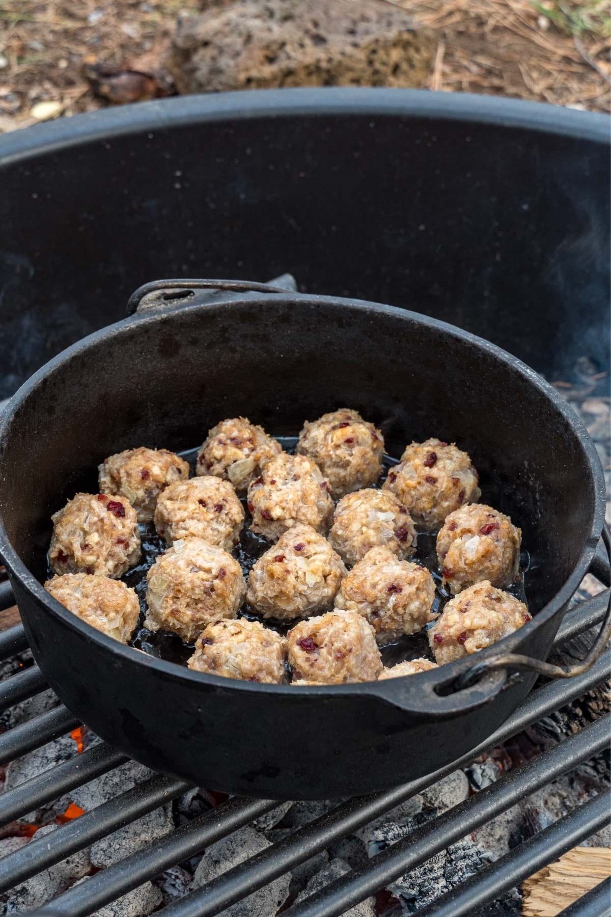 Turkey meatballs in a dutch oven on a campfire