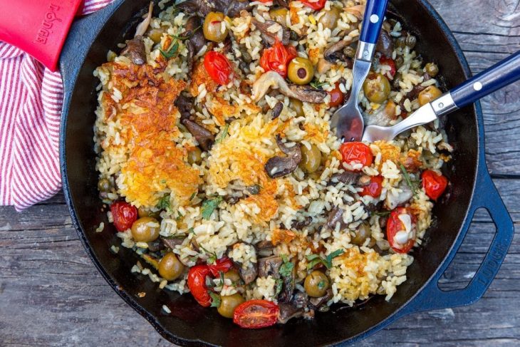 Vegan Paella in a skillet on a wooden table top