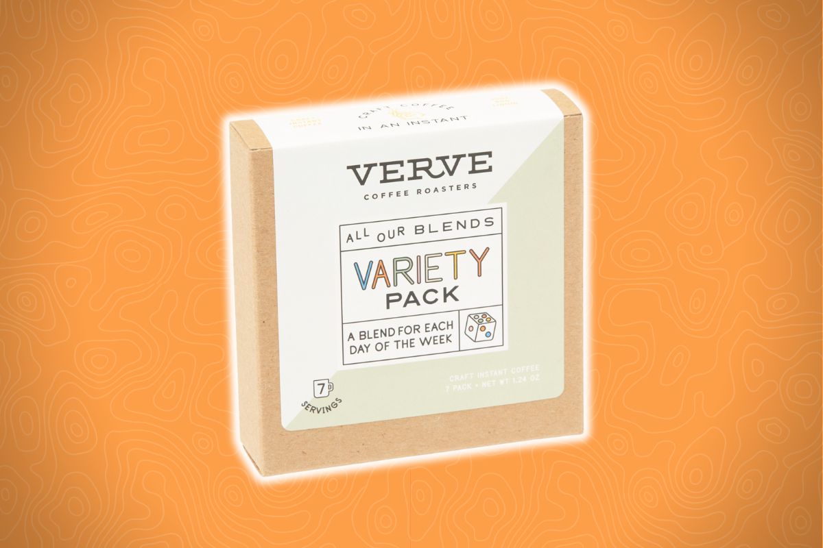 A light brown box with a white label and dice illustration sits against an orange patterned background.