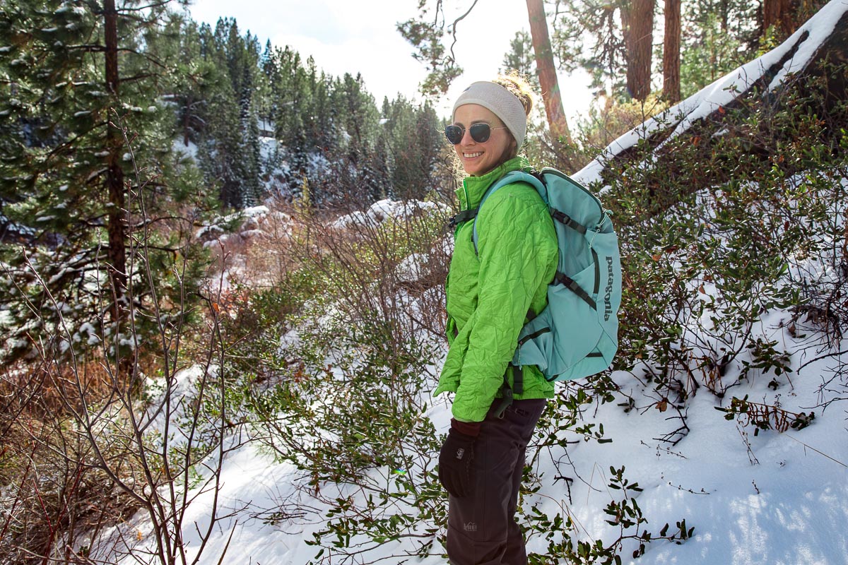 Megan smiling facing the camera during a winter hike
