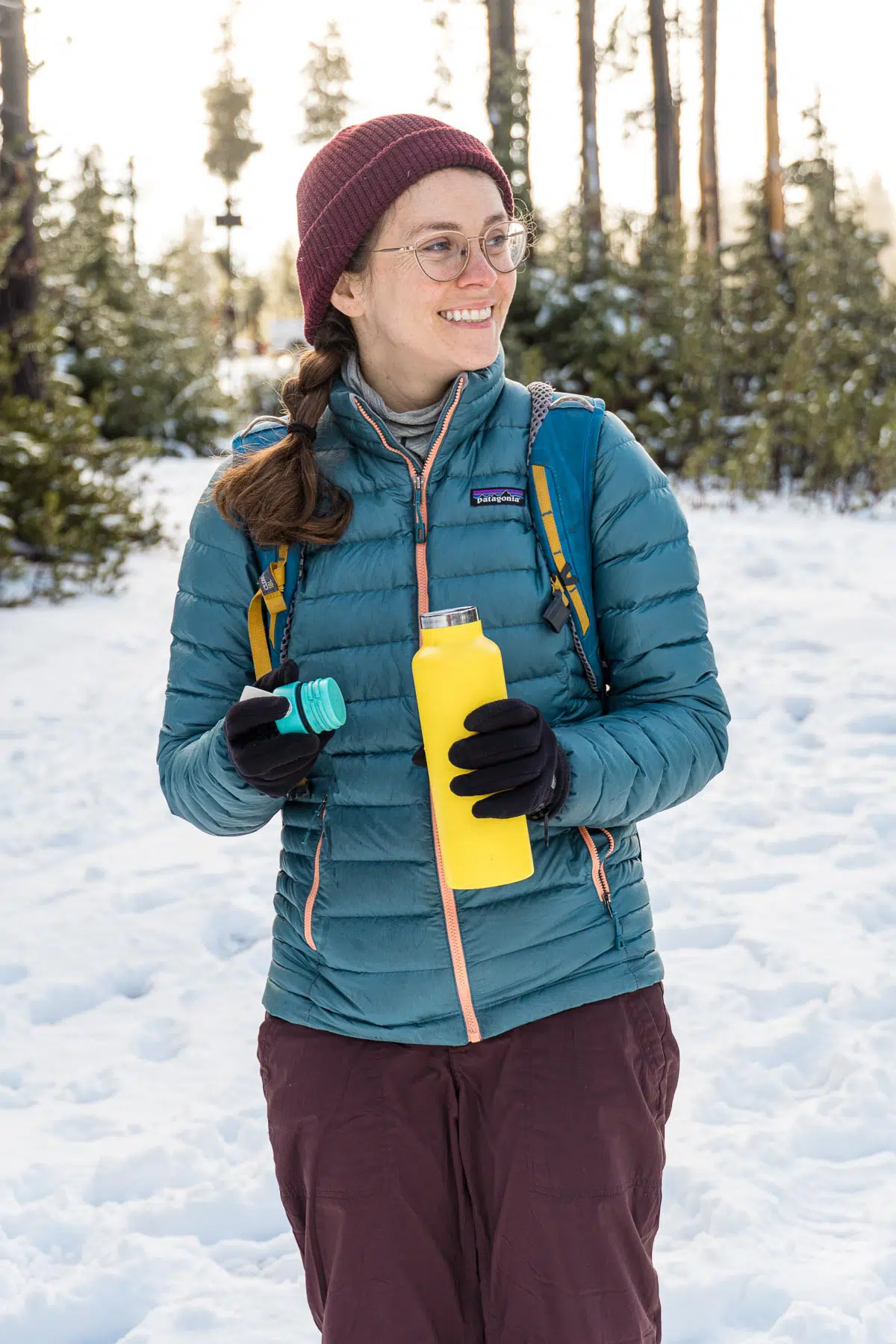 Megan holding an insulated bottle with a warm drink