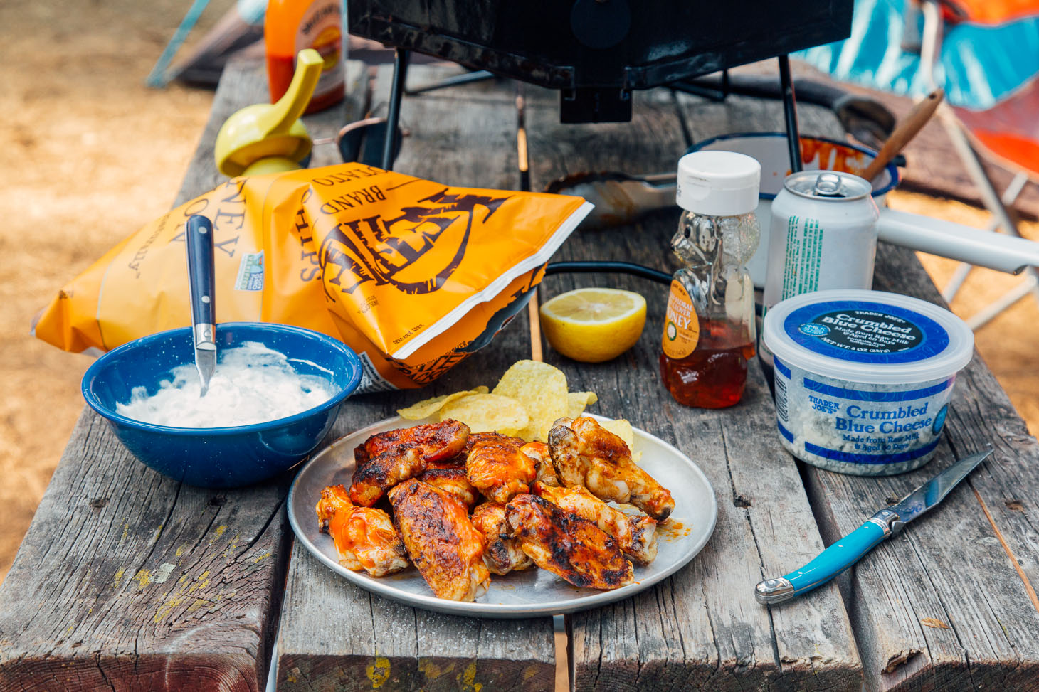 A camp table scene with a plate of grilled buffalo wings