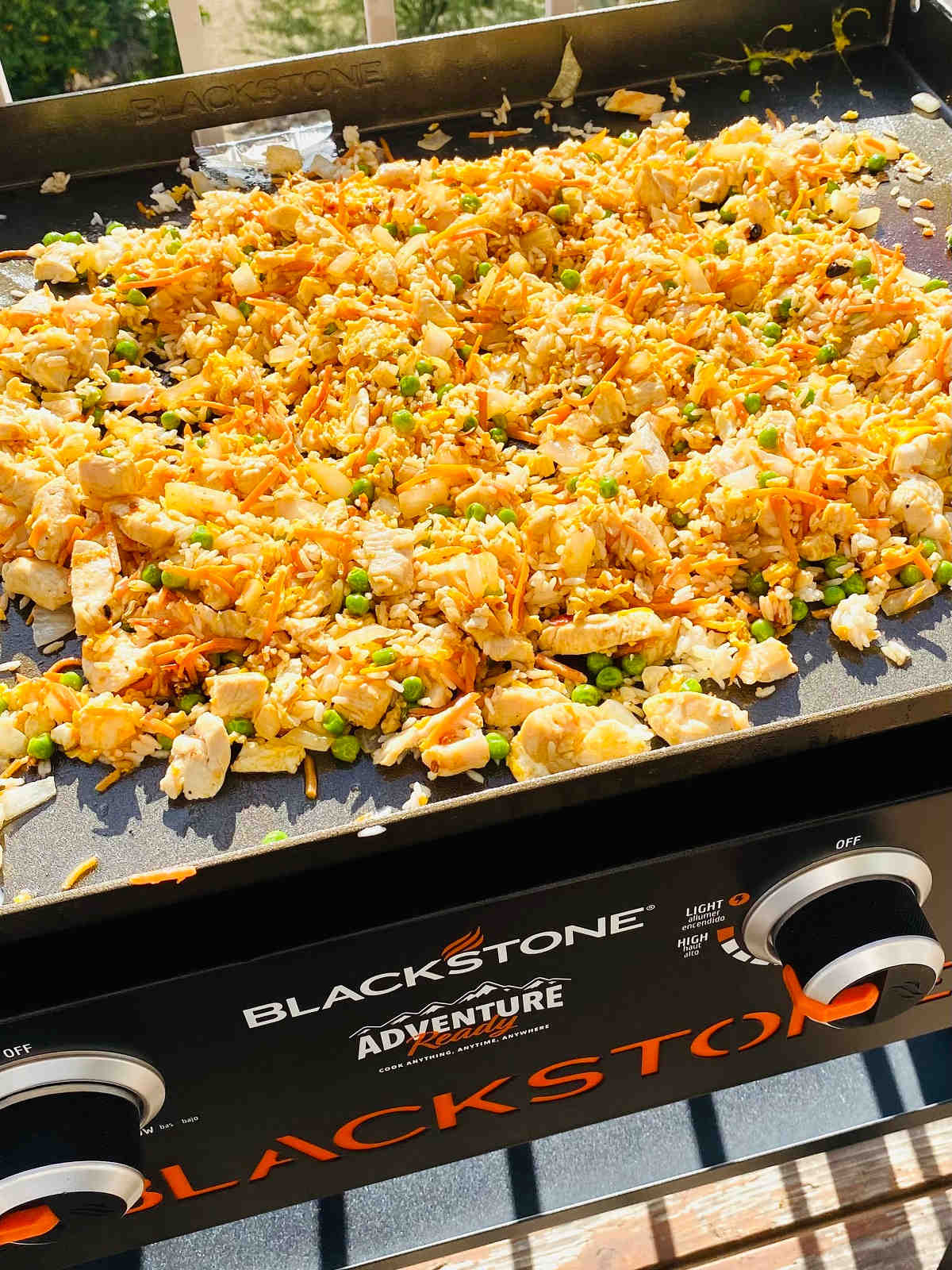 Fried rice being cooked on a blackstone griddle.