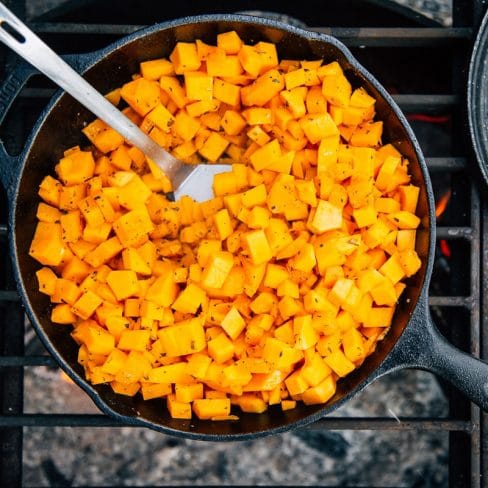 Cubed butternut squash in a cast iron skillet