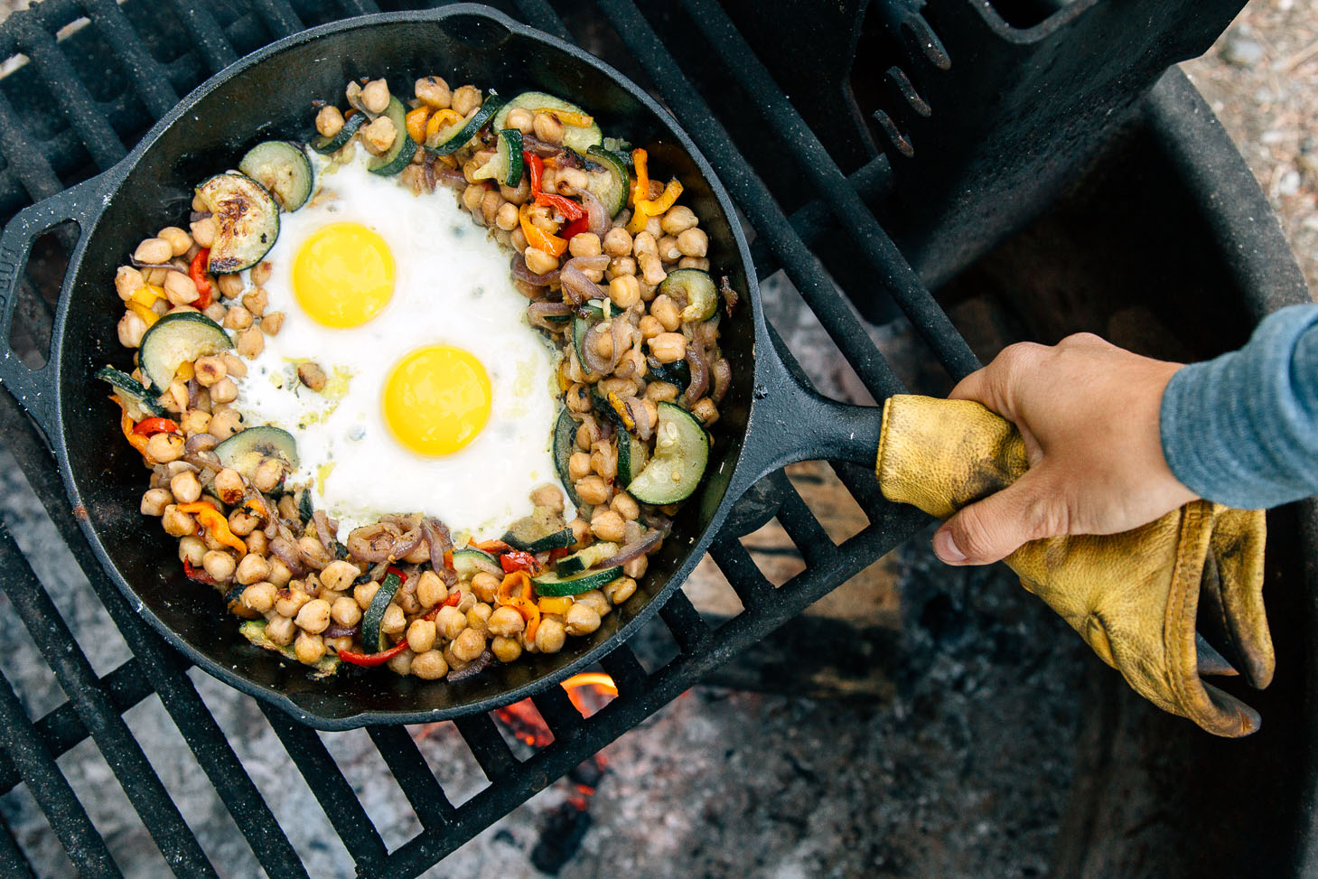 Cooking eggs in a cast iron skillet on a campfire
