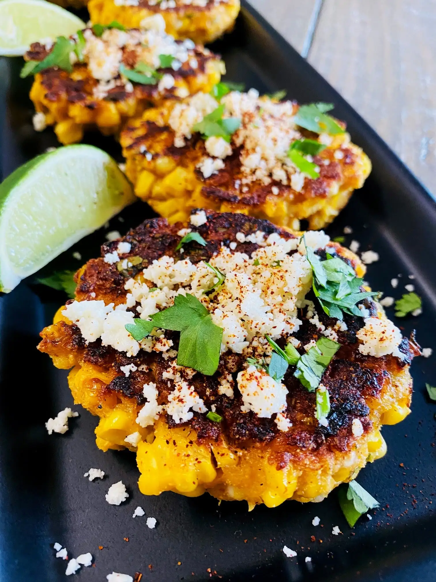 Corn fritters topped with cheese, spices, and cilantro.