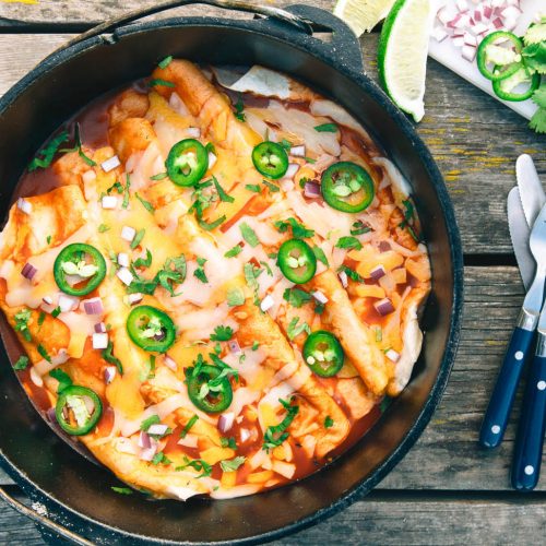 Enchiladas in a dutch oven on a table