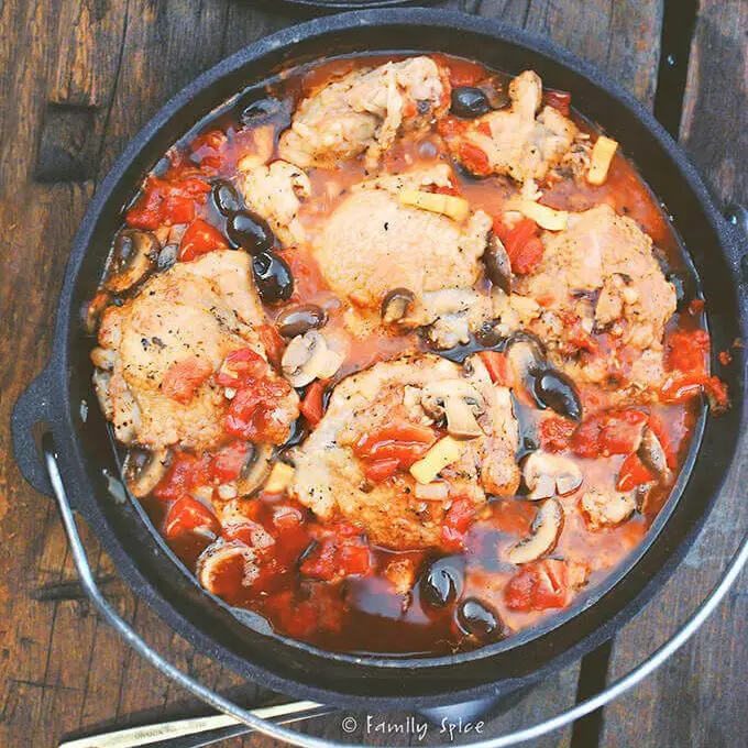 Chicken, olives, and tomato sauce in a dutch oven