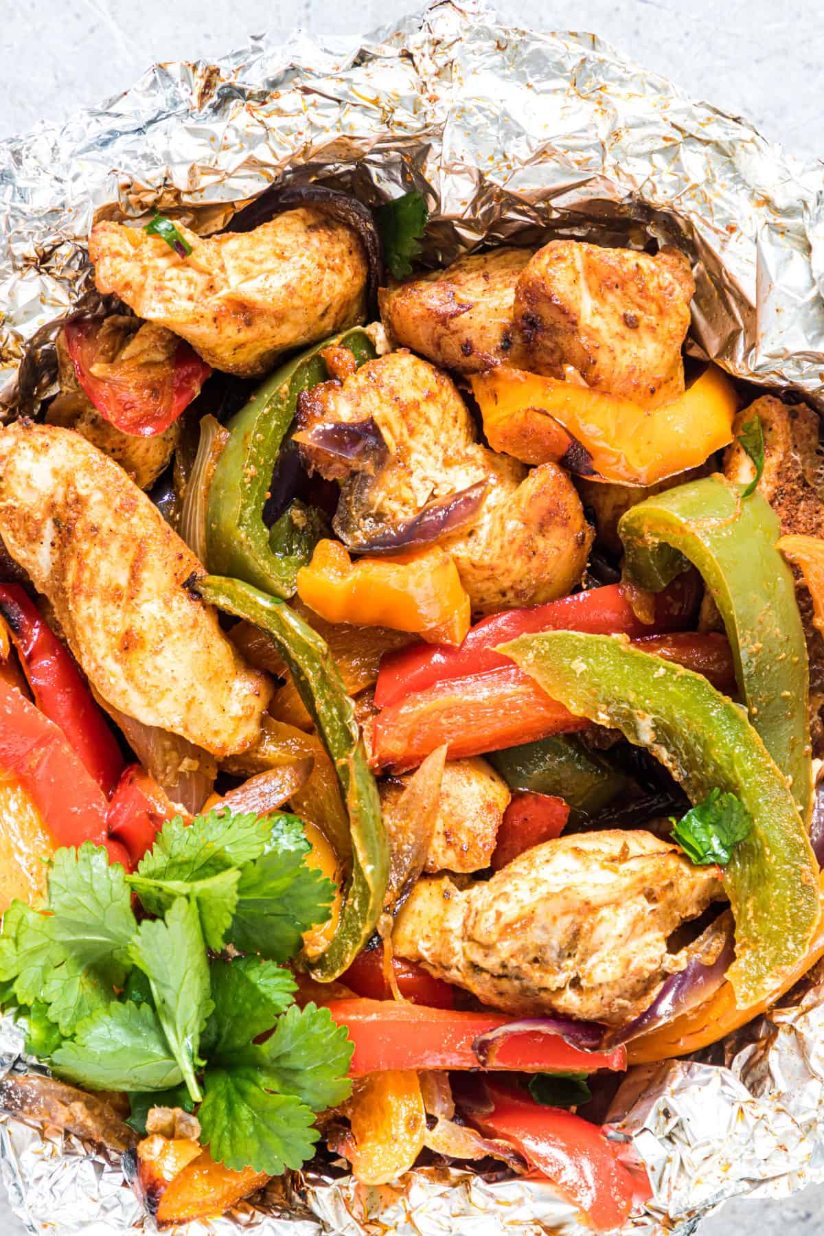 Strips of chicken and peppers cooked in foil.