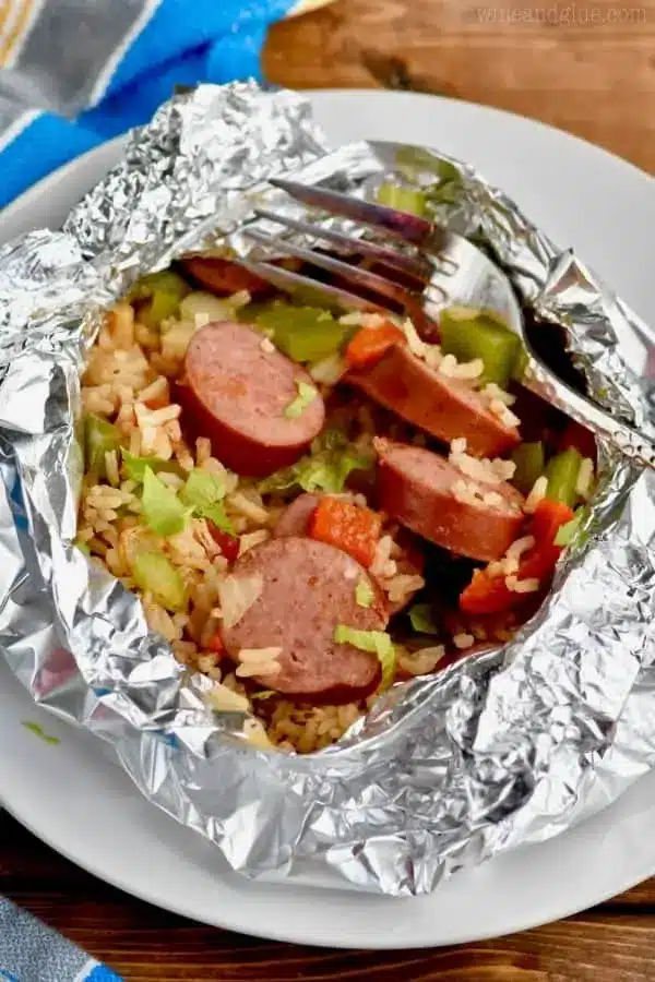 Sausages, chopped veggies, and rice in a foil packet.