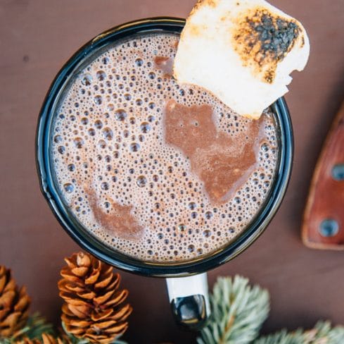 Nutella hot chocolate in a mug topped with a toasted marshmallow