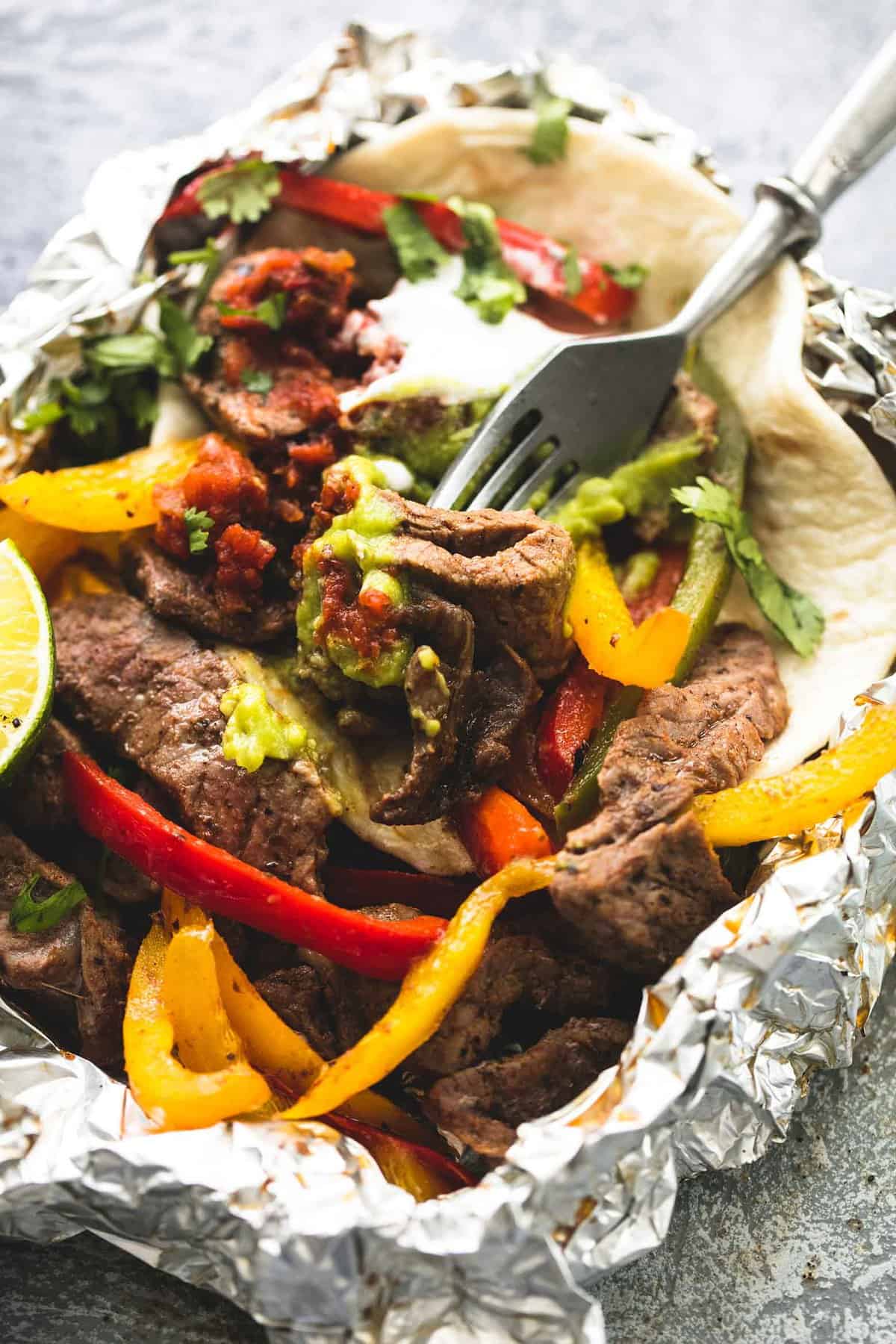 Strips of steak and peppers in foil.