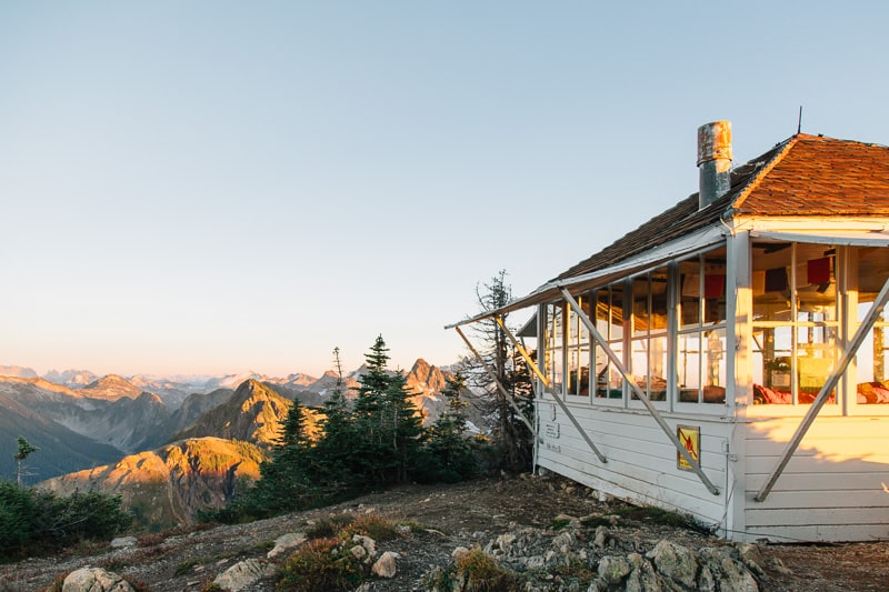 The Winchester Mountain Lookout Tower with mountain peaks in the distance.